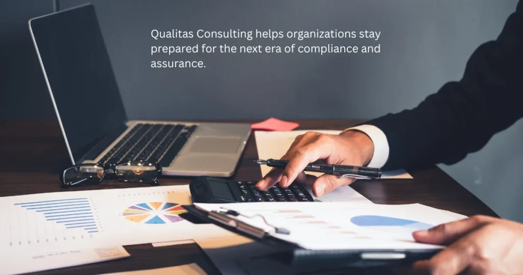 Business professional examining financial reports on laptop with calculator and charts, representing the future of audit, with modern compliance, assurance and audit consulting services in Qatar.